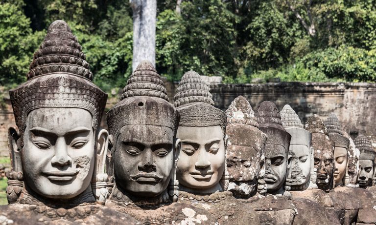 Heads of demons at entrance to south gate of Angkor Thom in Cambodia
