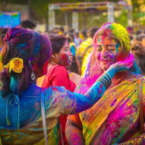 Friends with coloured dyes during Holi in Kolkata, India