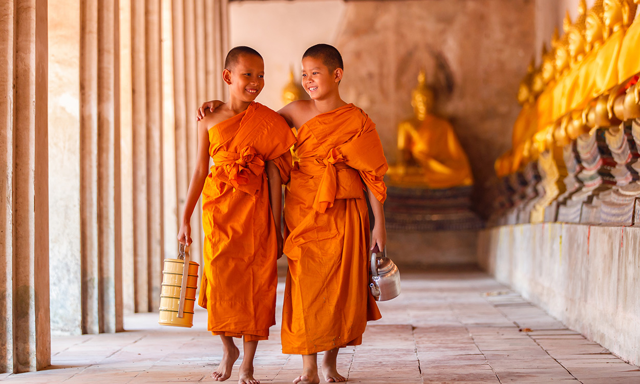 Two novice monks walking in temple, Ayutthaya, Thailand